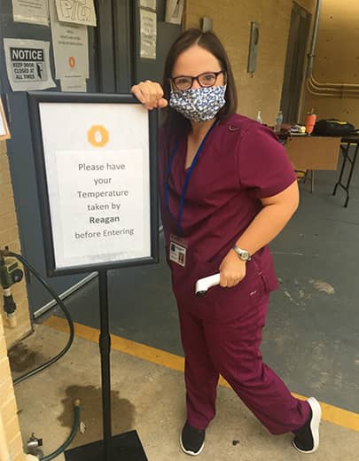 Reagan Brown takes temperatures of patients and visitors at Radiology Associates in Tallahassee, Florida.